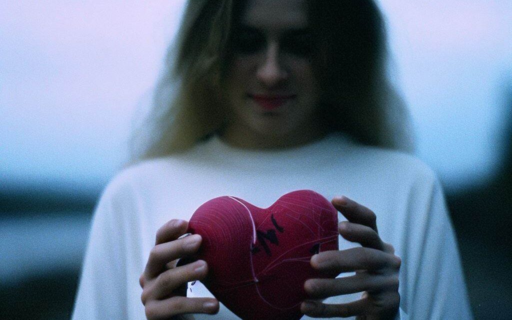 Image of a person holding a heart in their hand, trust, communication, boundaries, mutual respect, emotional intelligence, DSLR camera, 50mm lens, early morning, candid, Fujifilm Pro 400H